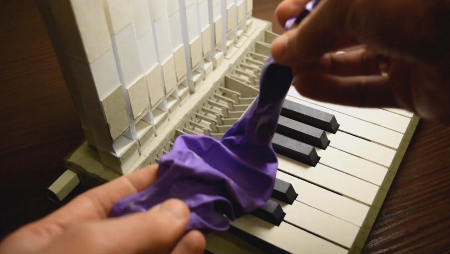 A pipe organ fashioned from paper card, with its air supplied by a deflating balloon