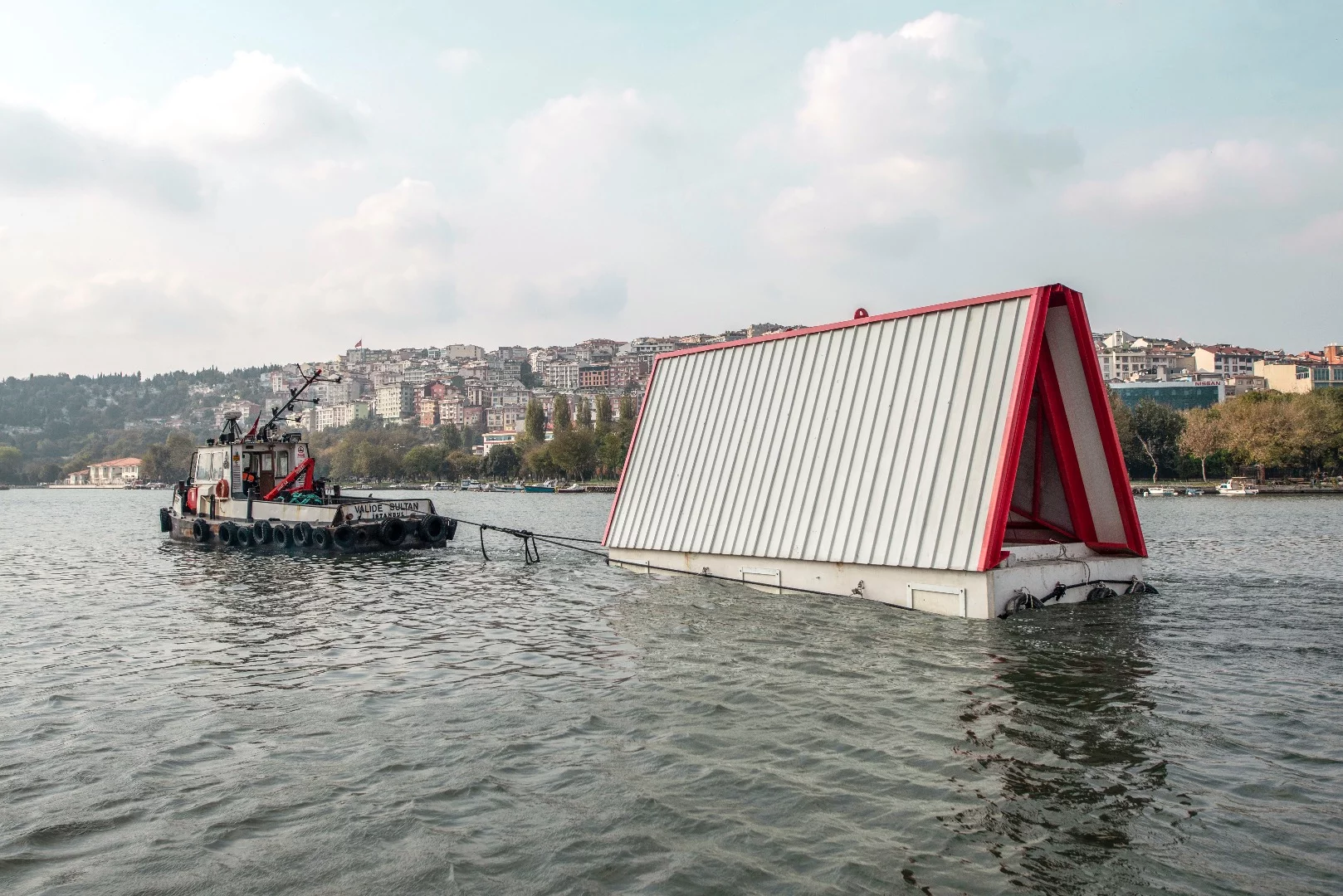 Fold&Float is made up of two main parts: a lower floating pontoon base made from concrete and an upper A-frame-like structure that includes all of the furniture fixed onto the walls