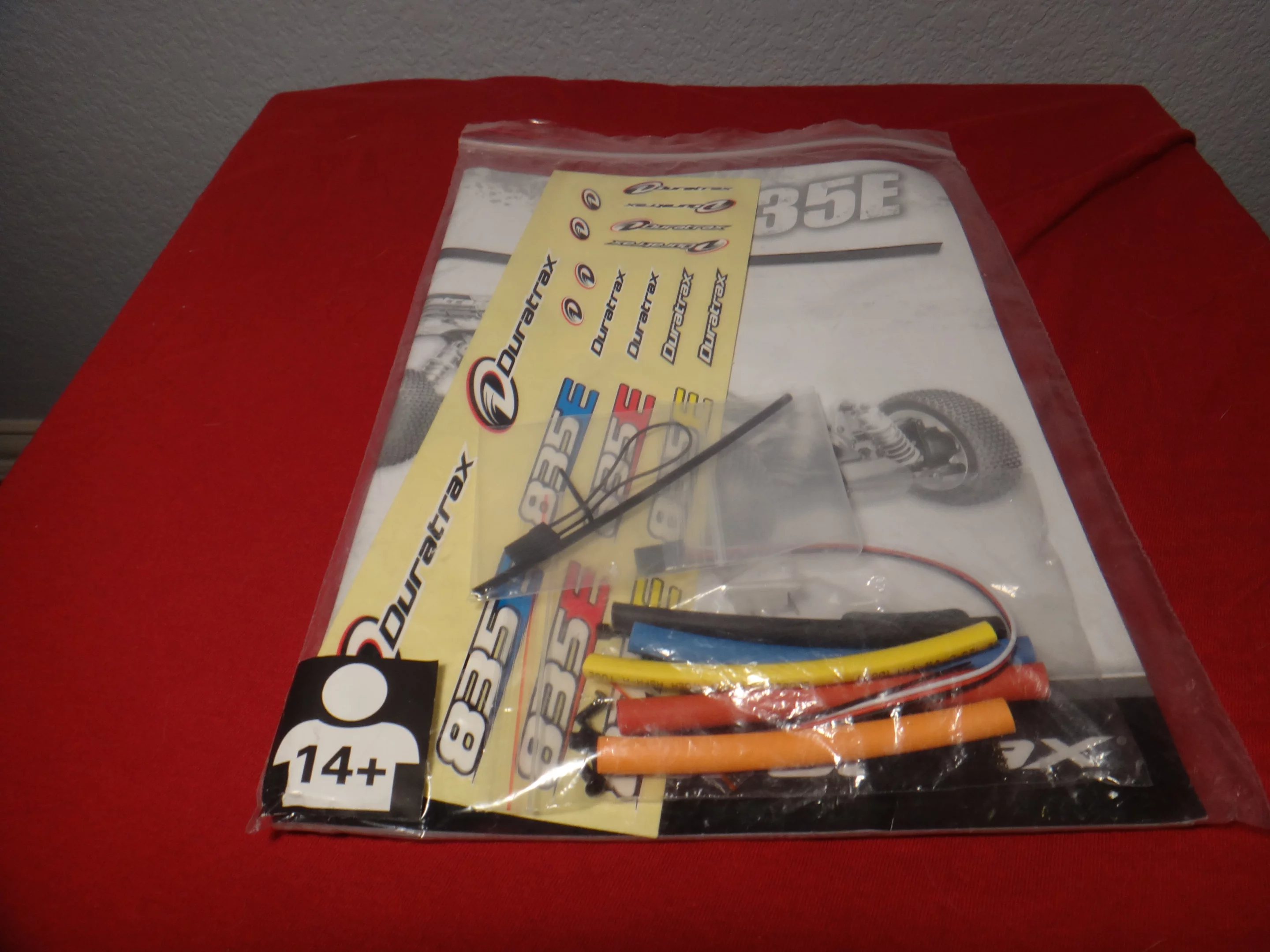 The Duratrax 835 E includes a a package of replacement parts, a sheet of decals, and an instruction manual