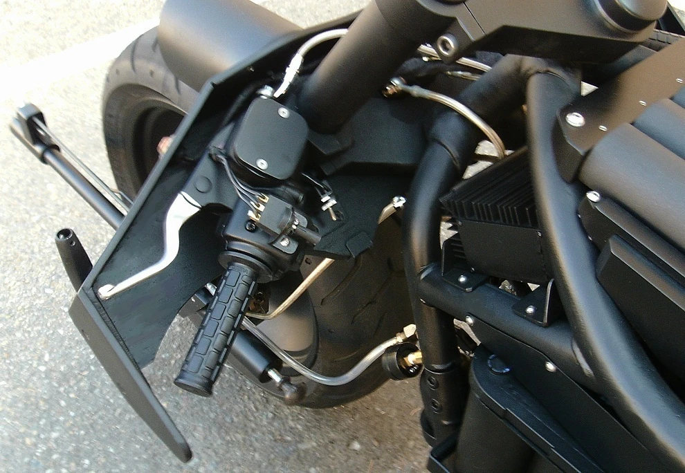 The handlebars are protected by a cowling