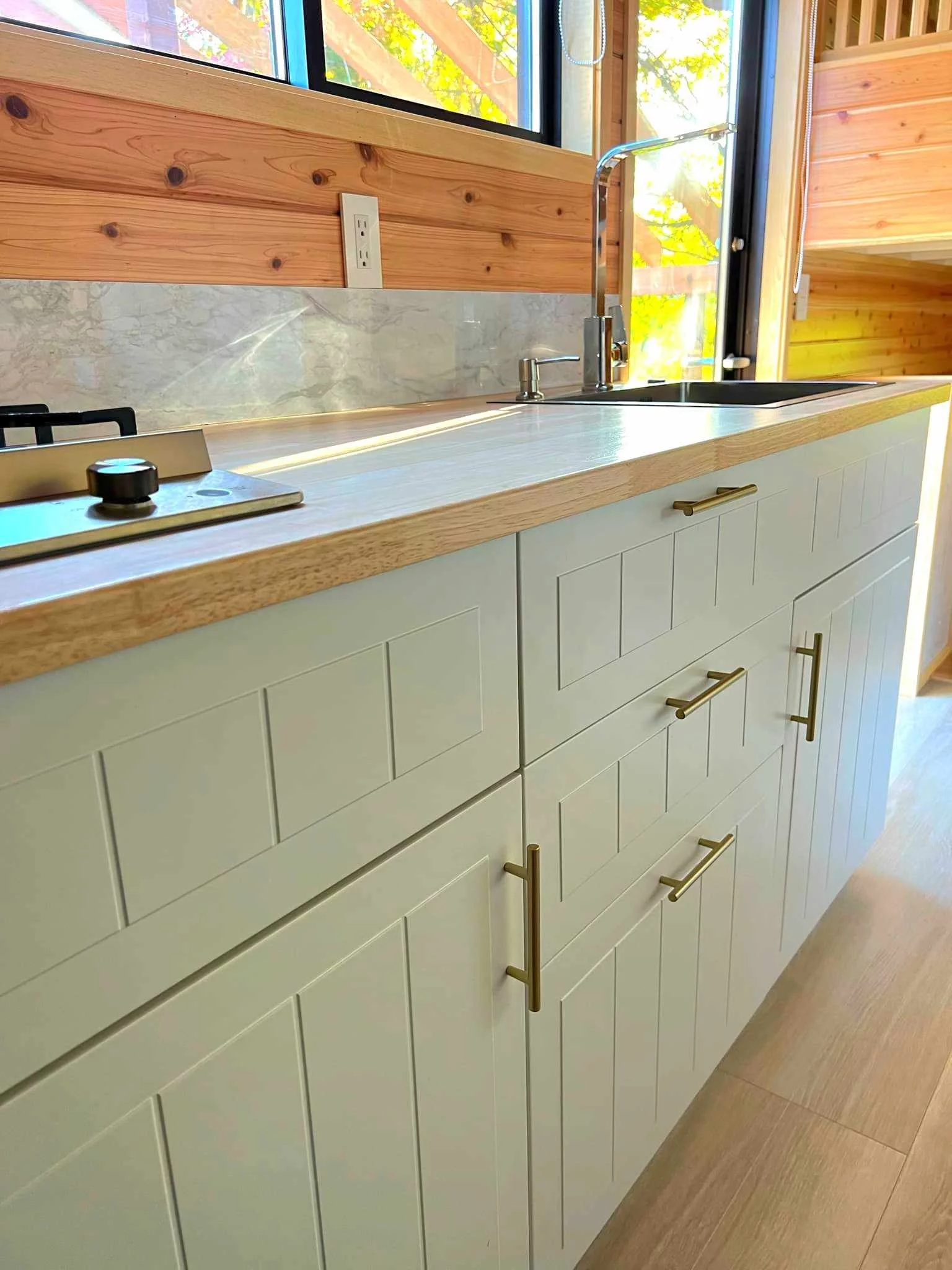 The Nozawa's kitchen has quite a lot of cabinetry for a compact tiny house