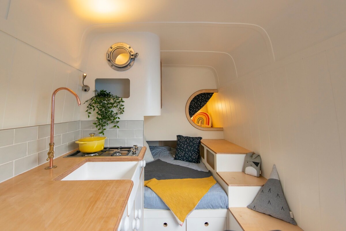 The added bonus of this specific conversions is its creative stacked pod beds, allowing the mobile home to sleep up to four adults comfortably