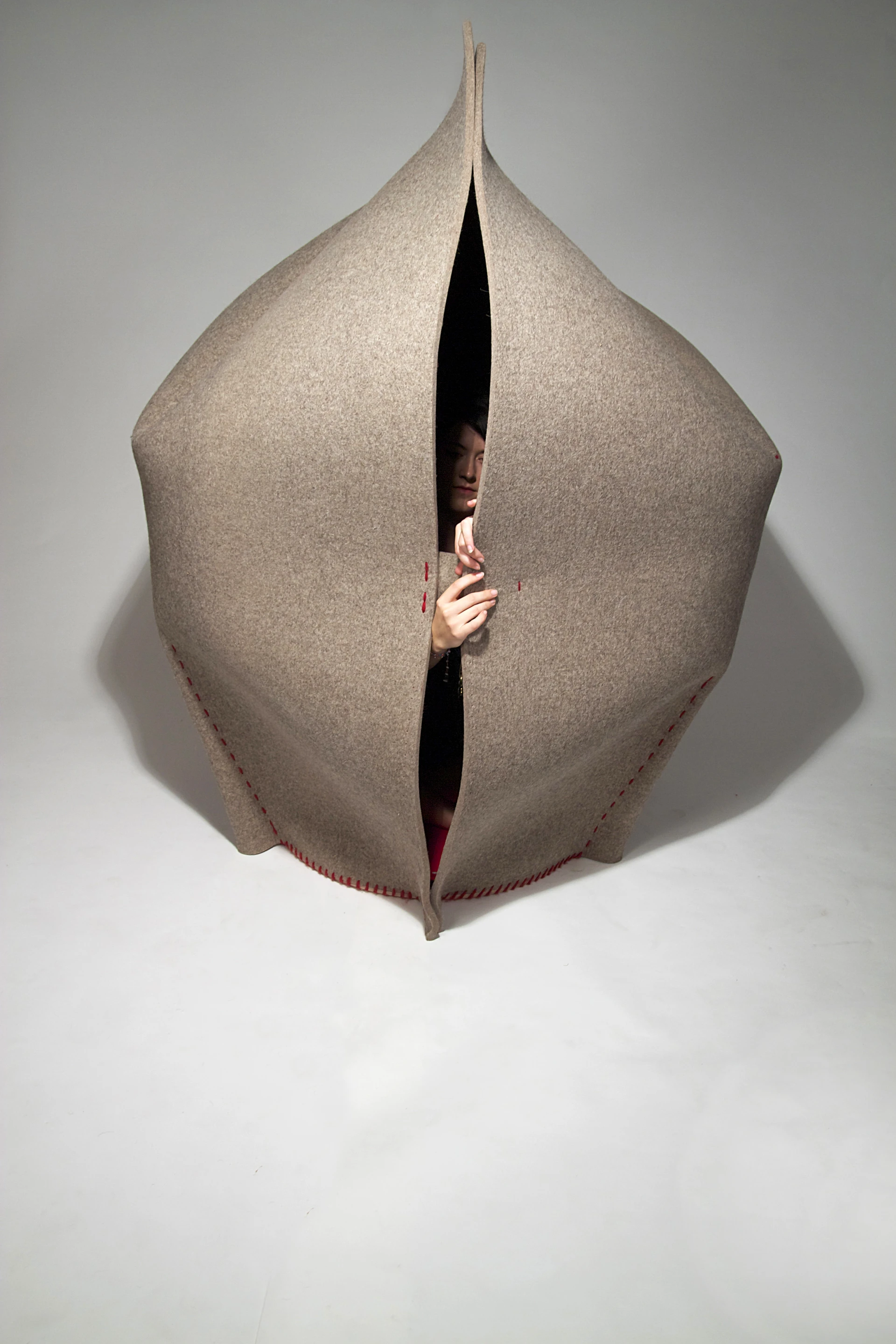 Made from a single piece of water jet-cut 12-mm thick (0.5-in) industrial felt 1750 x 4000 mm (69 x 157 in) in size, HUSH is sewn by hand with 150 meters (490 feet) of wool yarn