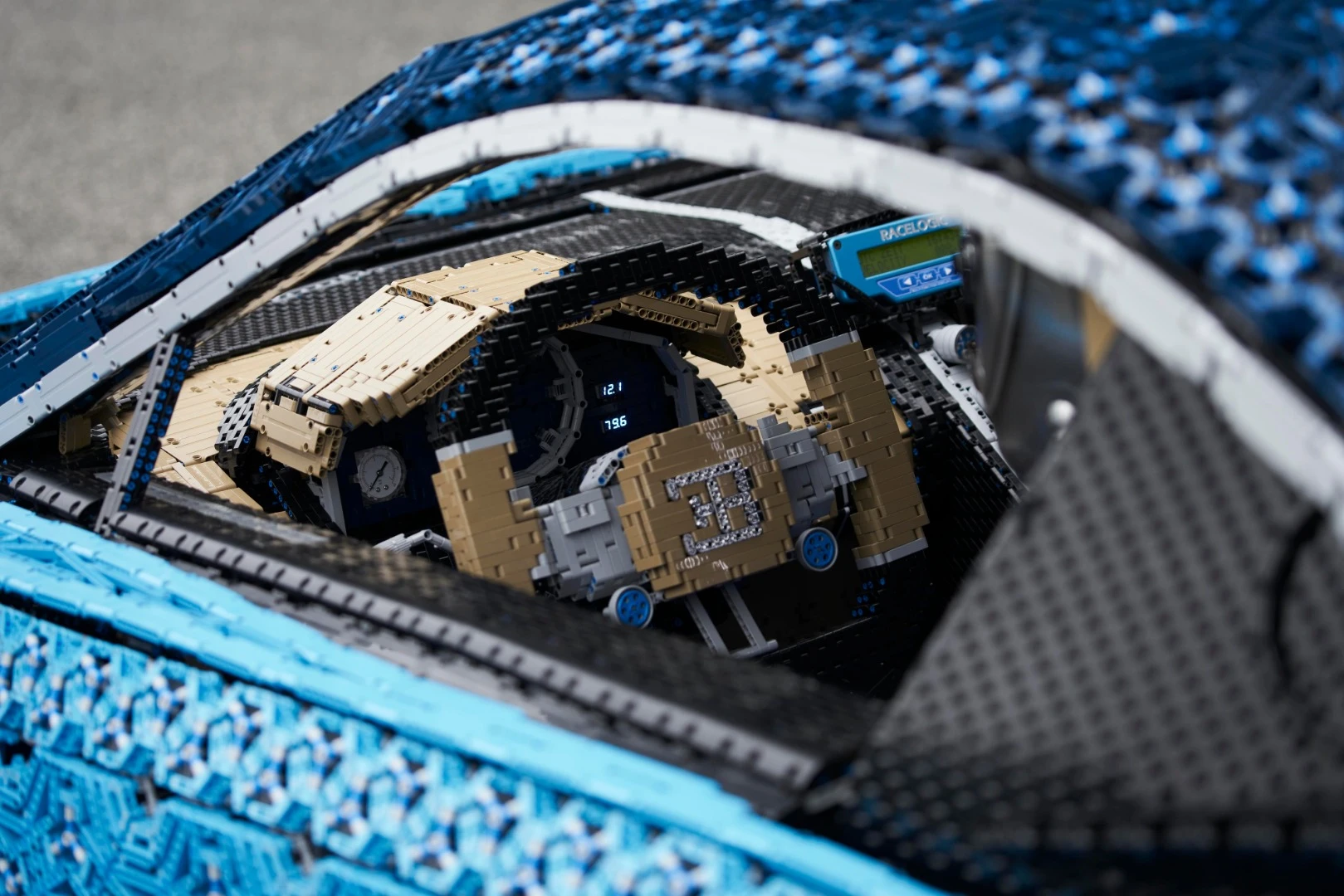Inside, Lego elements are used to create the steering wheel, brake pedal, speedometer, and all other interior elements