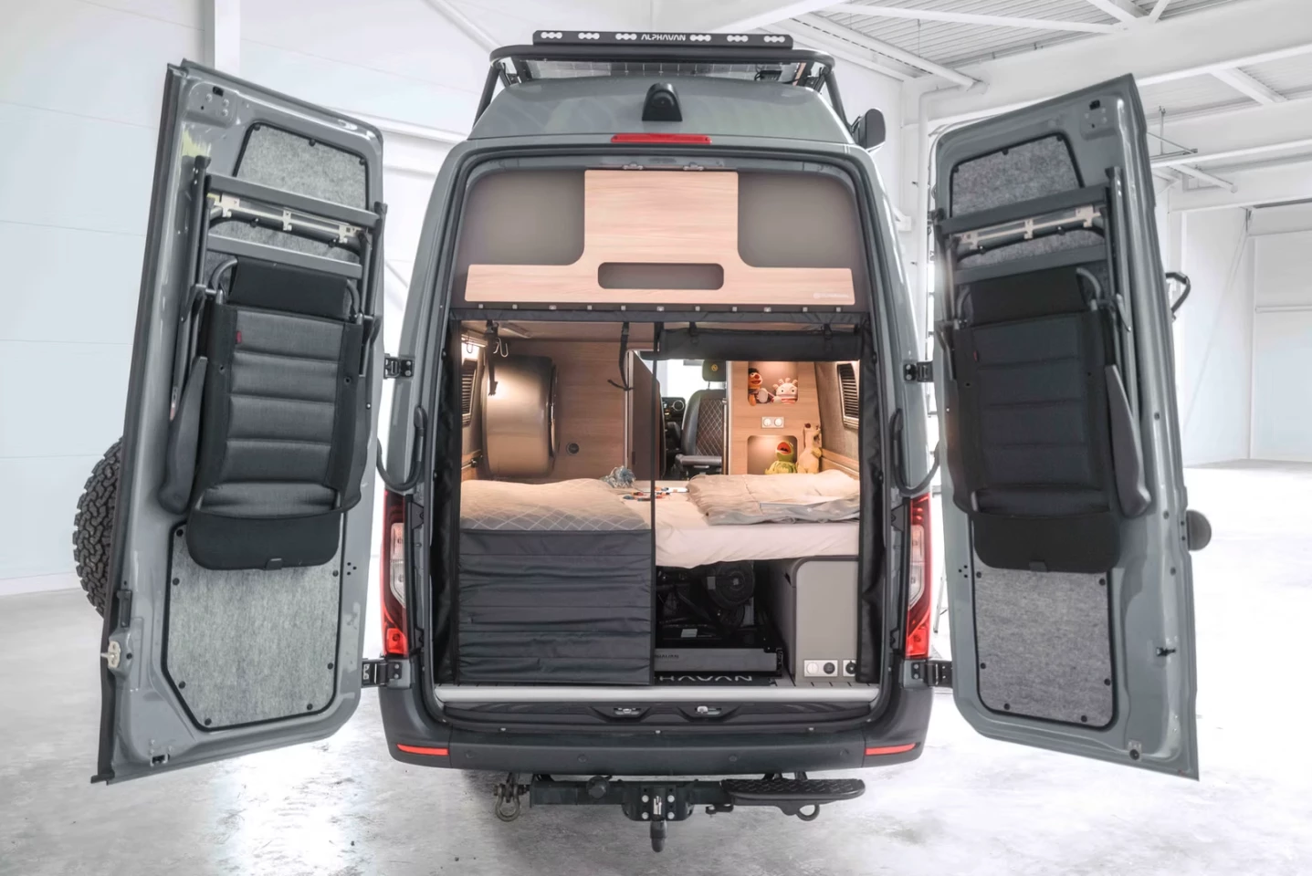 The rear space is designed to be a dedicated downstairs children's bedroom, a gear and cargo garage, and a laundry room, all in one