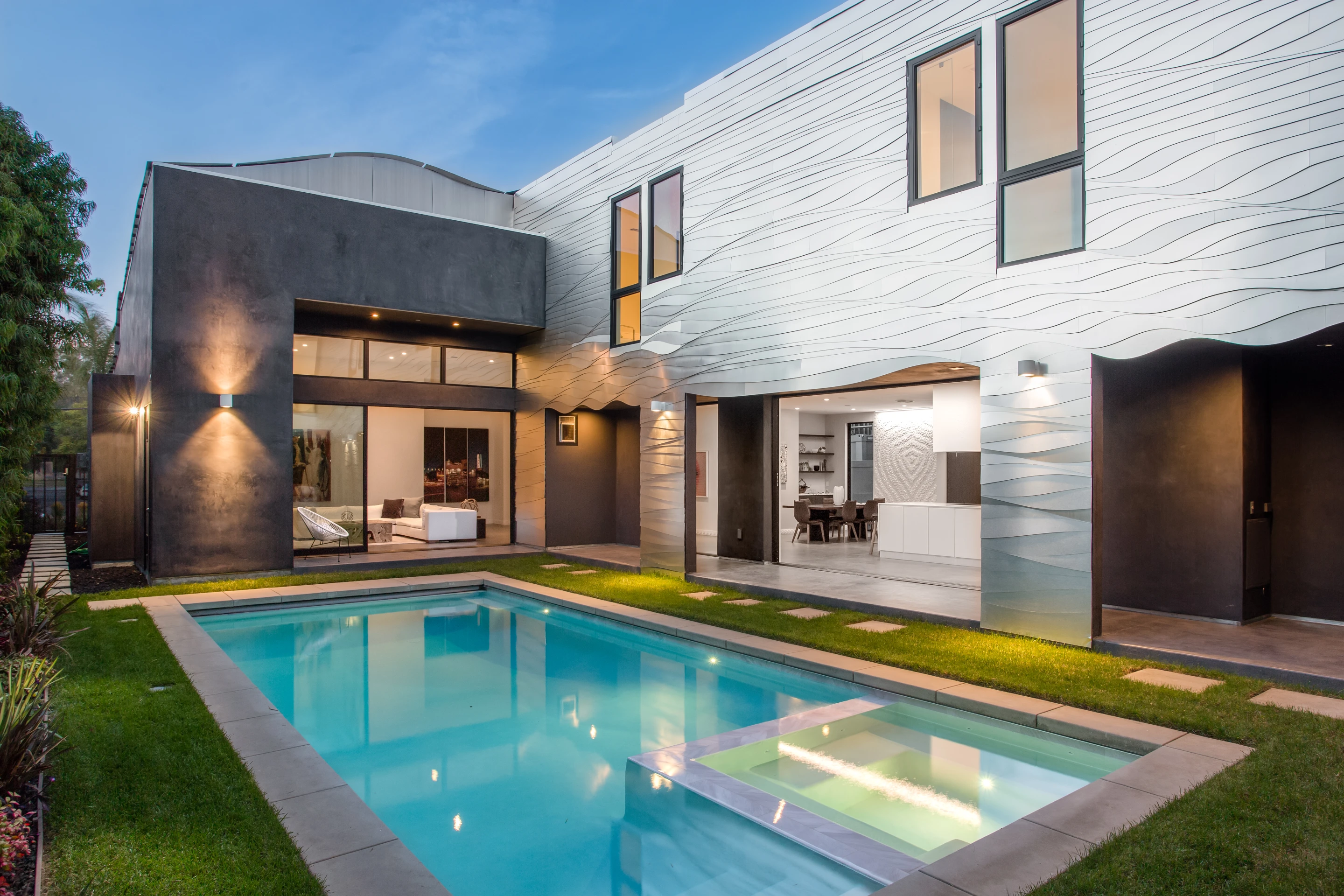 Sliding glass doors open the Wave House's kitchen and dining area to the garden