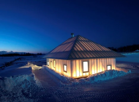 The building has a luminous glow when viewed from the outside at night