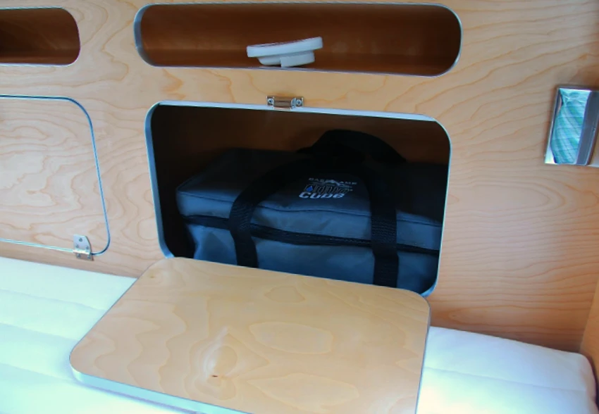 The headboard includes large storage compartments for clothes and bags along with small, easy-access cubbies