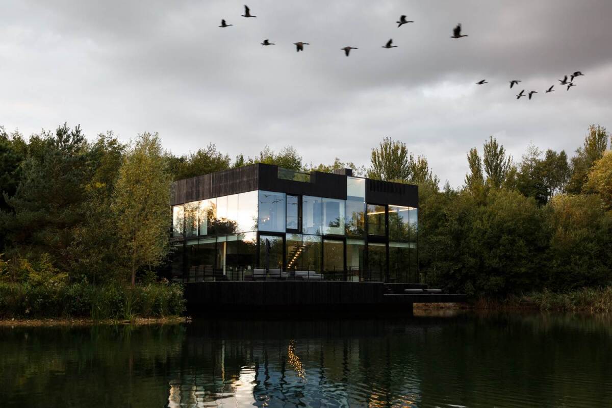 Shimmering sustainable home on the lake uses glass to give residents a