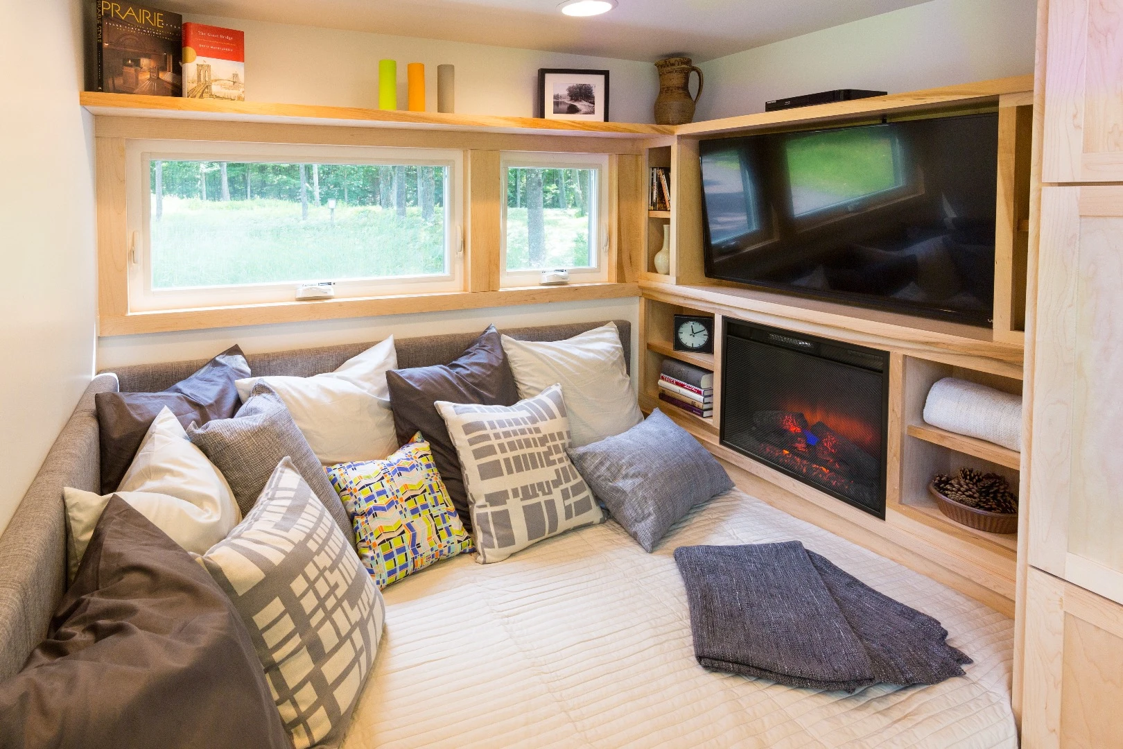 The lounge includes a sofa bed, television, and electric fireplace