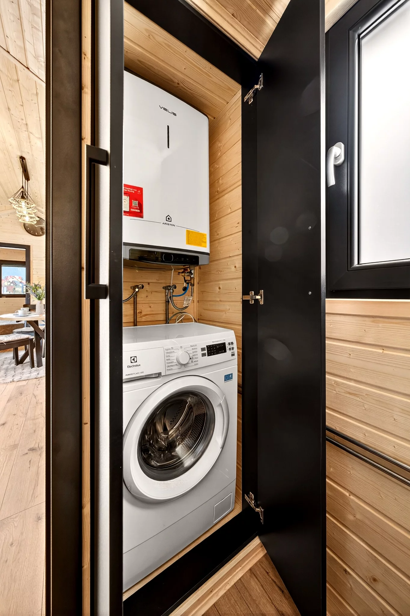 The Justine's bathroom hosts a washer/dryer and water heater within a cupboard
