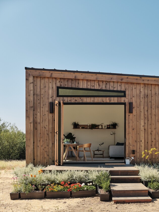 Tri-folding glass doors open the home to the outdoors