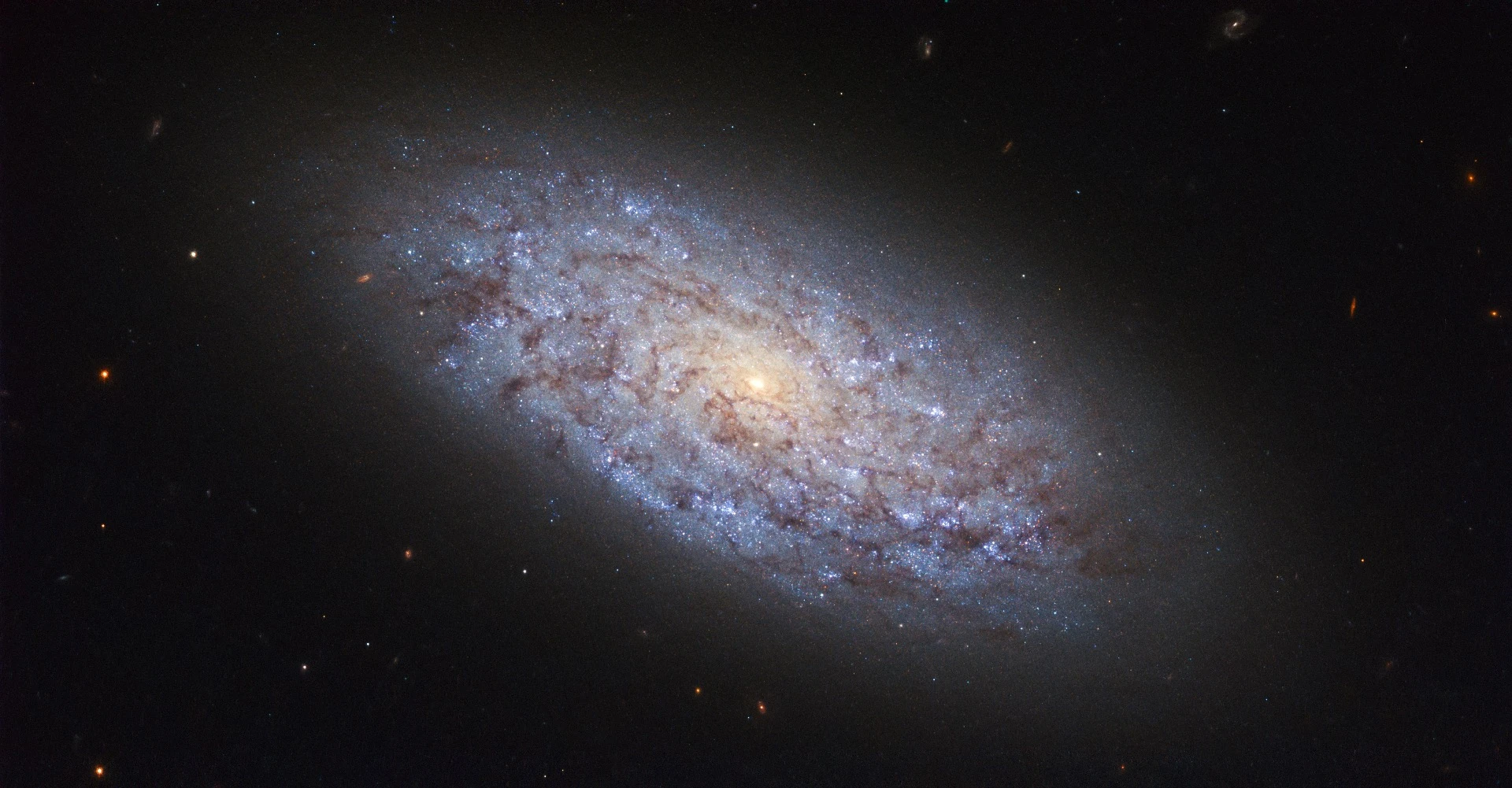 The subject of this NASA/ESA Hubble Space Telescope image is a dwarf galaxy named NGC 5949