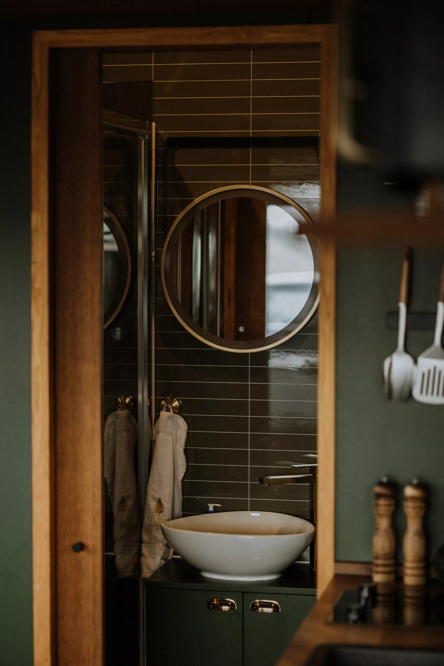 The Tiny Amsterdam's bathroom is small but includes a vanity sink, a shower, and a flushing toilet