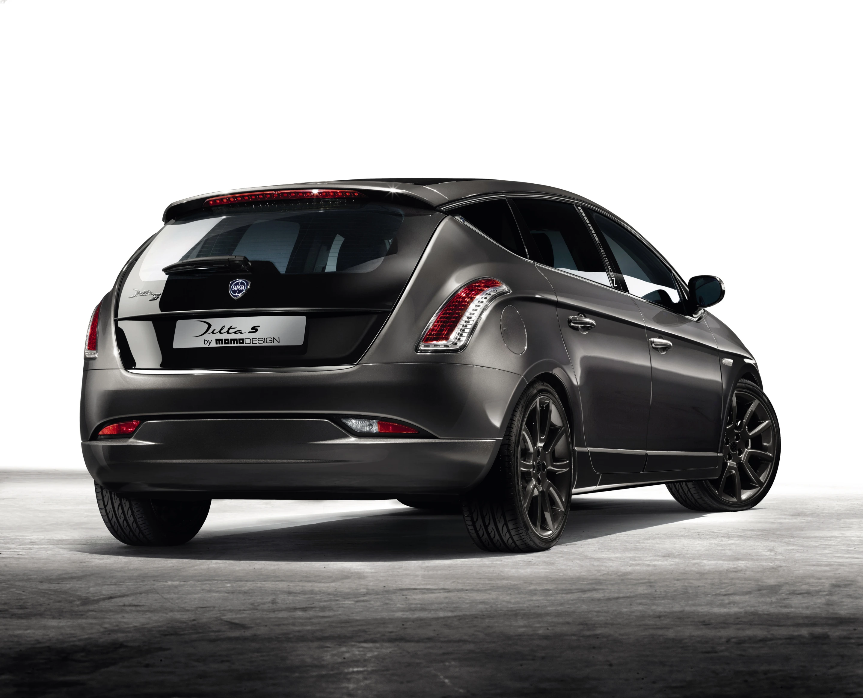 Rear taillights curve up and over the rear fender, blending into the descending waistline treatment that brackets the narrowed hatch