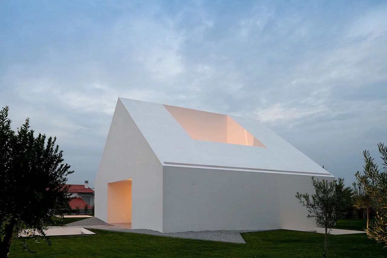From Aires Mateus Architects this home is simple called ‘House In Leiria’. Almost all of the house is built underground with a doorless, and windowless monolithic impression of a house standing above the ground