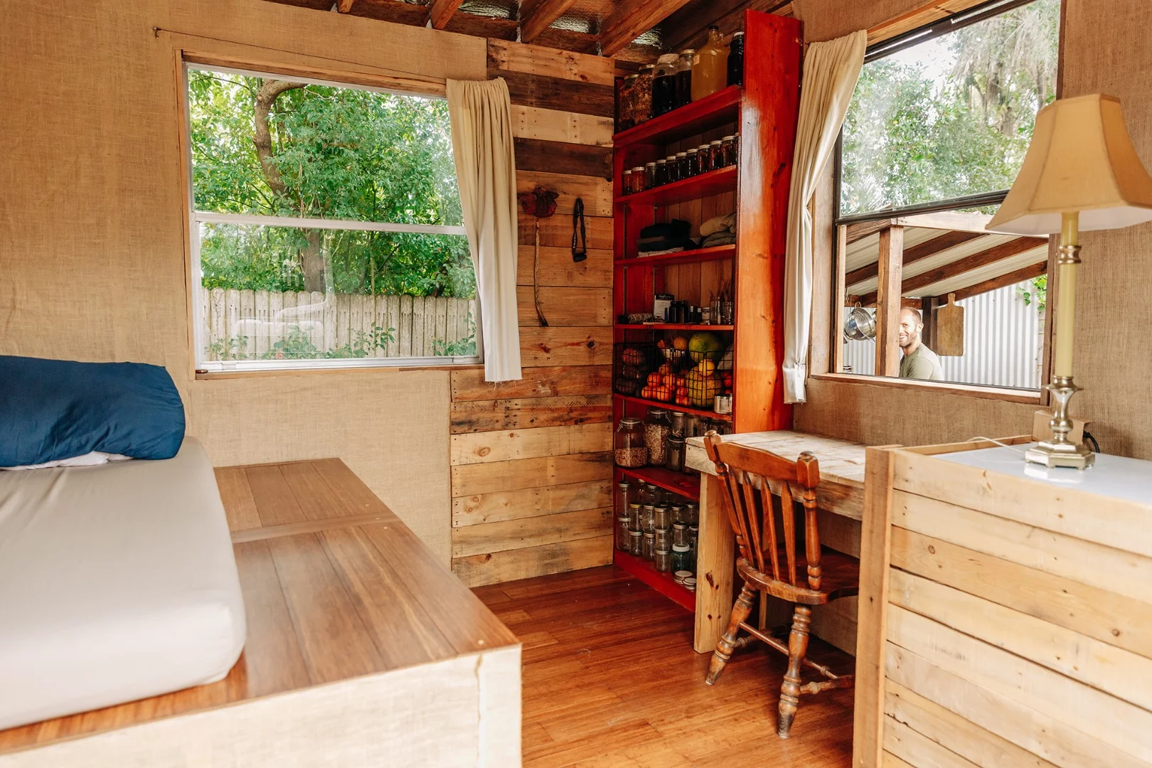 The tiny house includes a small desk made from wood scraps