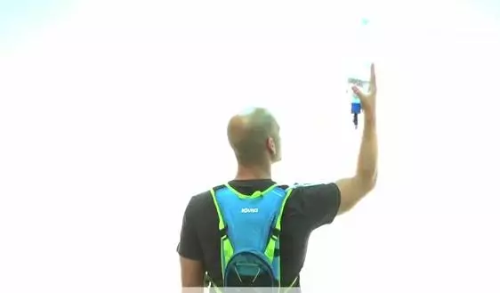 When using a bottle simply hold it above your pack so that water drains via gravity