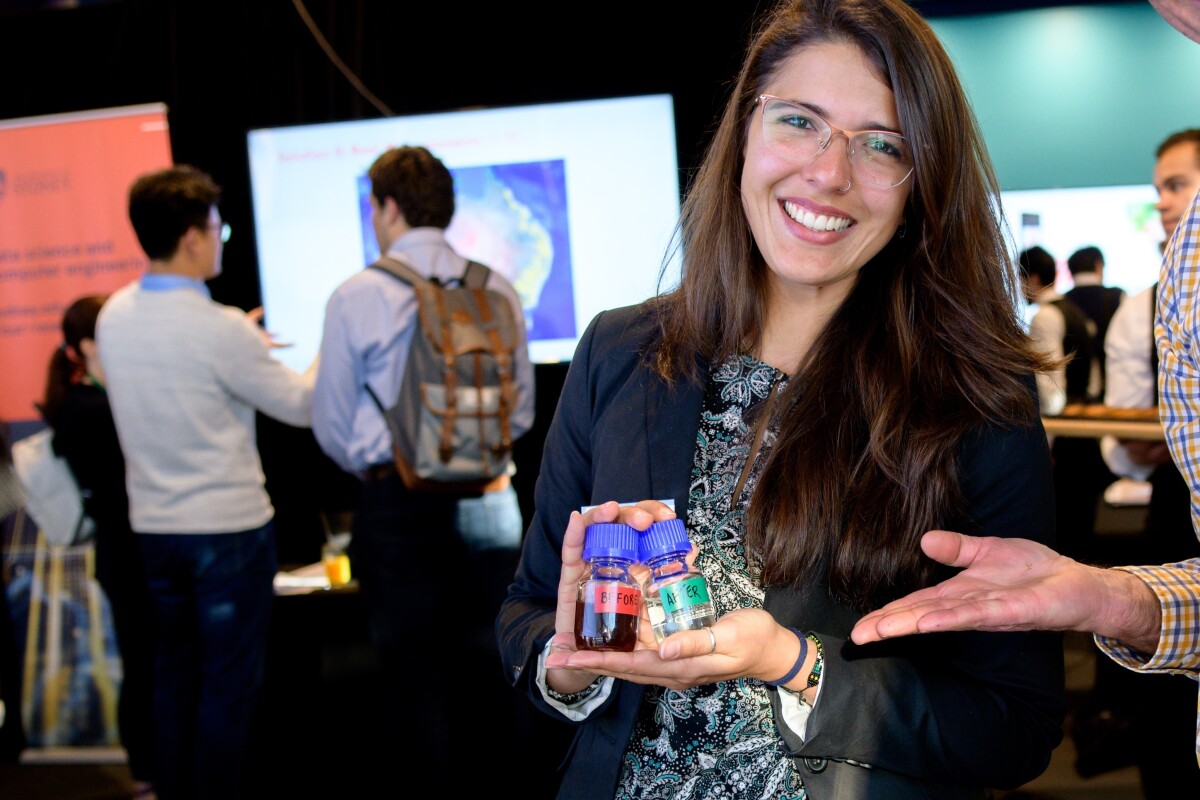 Lead researcher Julia Ciarlini Jungers Soares holds "Before and After" samples of the wastewater