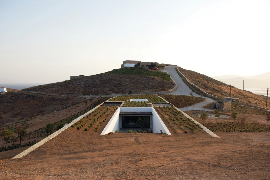Aloni House sits in a natural gully between two sloping hills. Much of the structure nestles under the ground making it nearly impossible to grasp its true scale