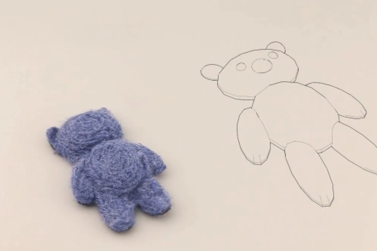 One of the finished felt teddy bears, alongside its digital model
