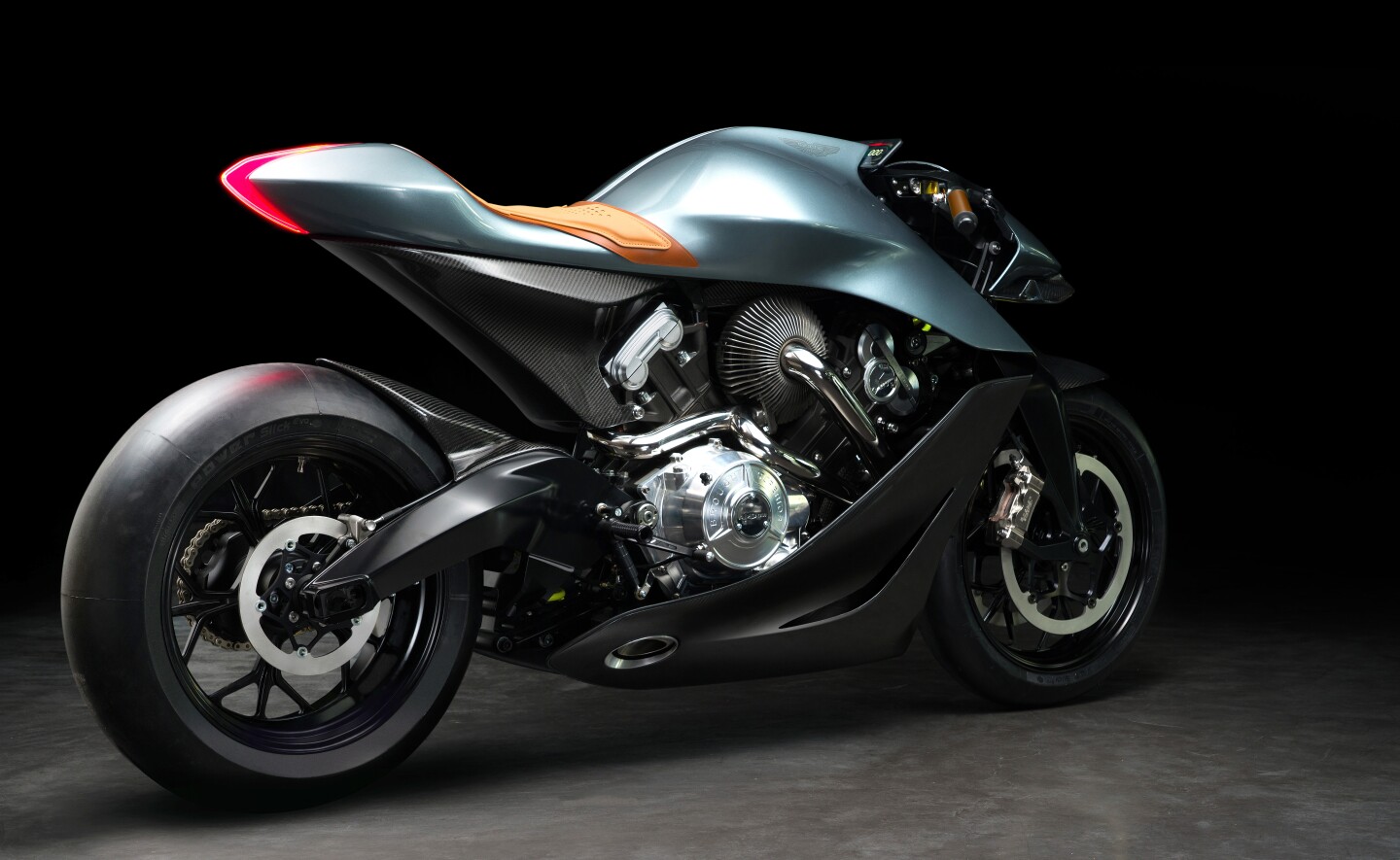 A curvy, machined swingarm beneath a carbon subframe and bodywork