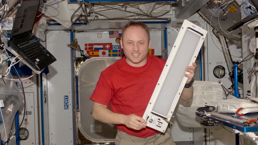 Astronaut Michael Fincke showing off one of the LEDs