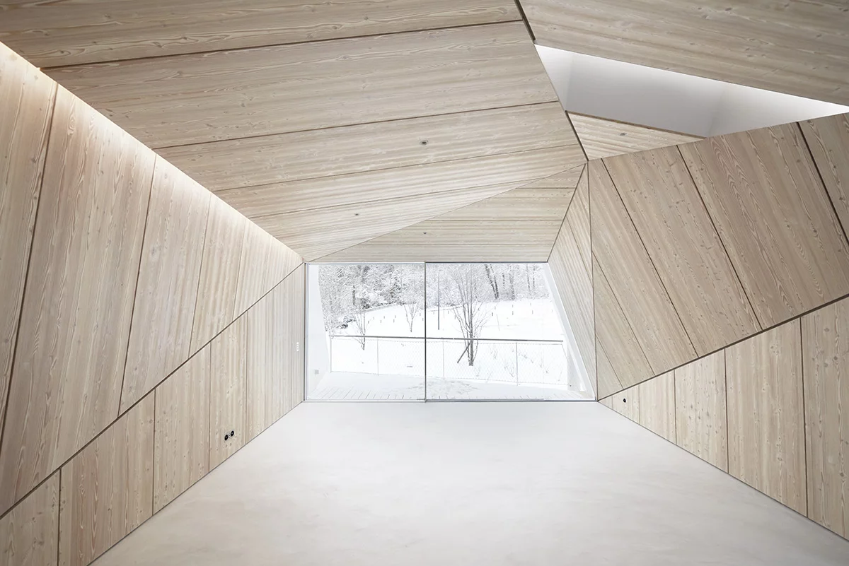 Wooden panels elegantly frame the large floor-to-ceiling window, transforming the view into a work of art