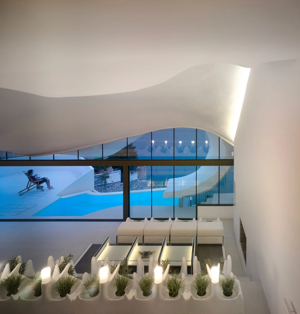 The interior includes a large terraced living area that is connected to a cantilevered terrace with swimming pool