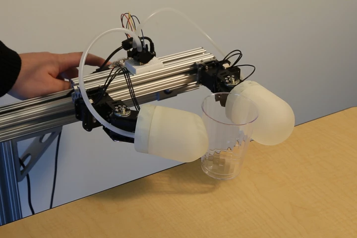 Disney's inflatable grasping modules pick up a plastic cup without crushing it