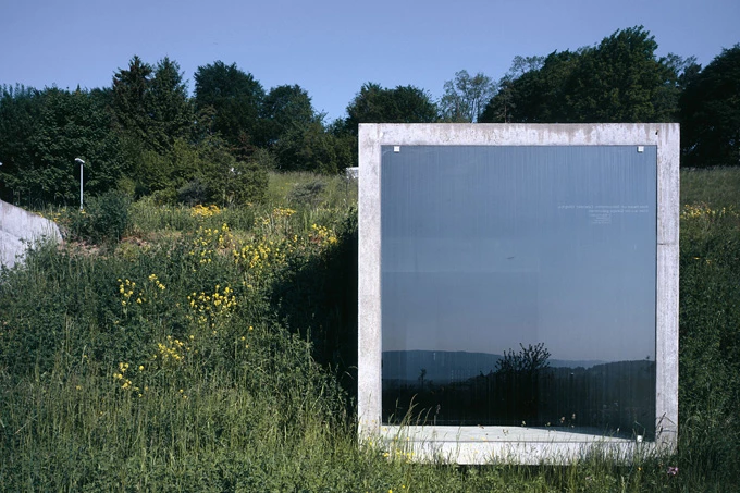 The concrete cubes are furnished with a single glass panel window, creating a dramatic outlook onto the adjacent valley