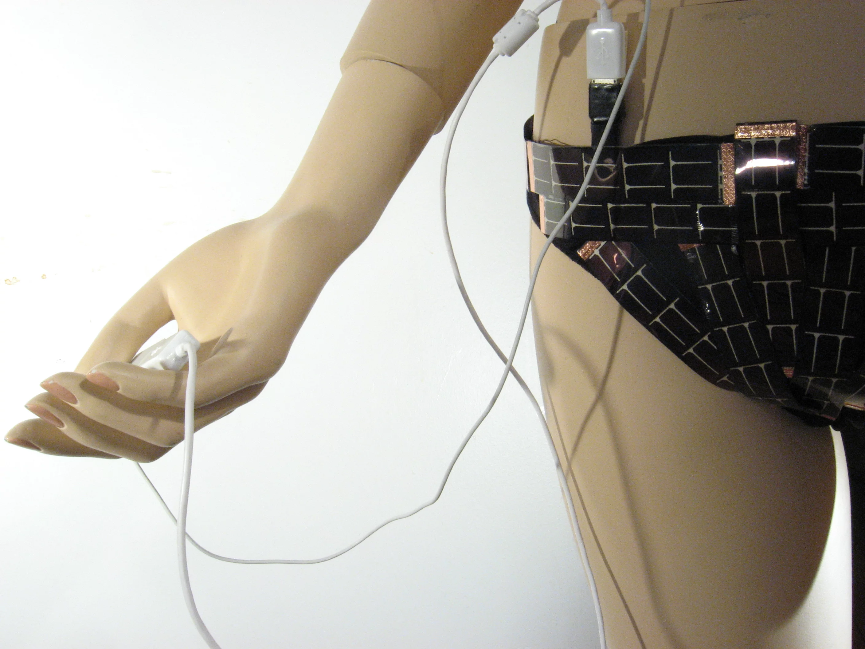 The conductive wire stitched through and connecting the photovoltaic cells of the Solar Bikini ends in a female USB port for connecting digital devices (Photo: Andrew Schneider)