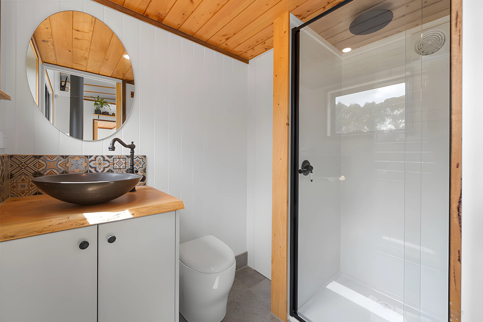 The Grevillea's bathroom features a shower, vanity sink, and a composting toilet