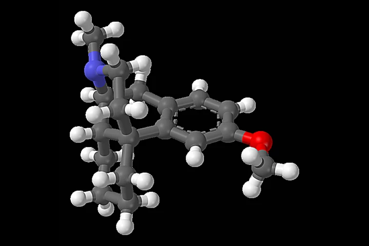 Ball and stick model of dextromethorphan - gray are carbon atoms, white are hydrogen, blue is nitrogen, and red is oxygen