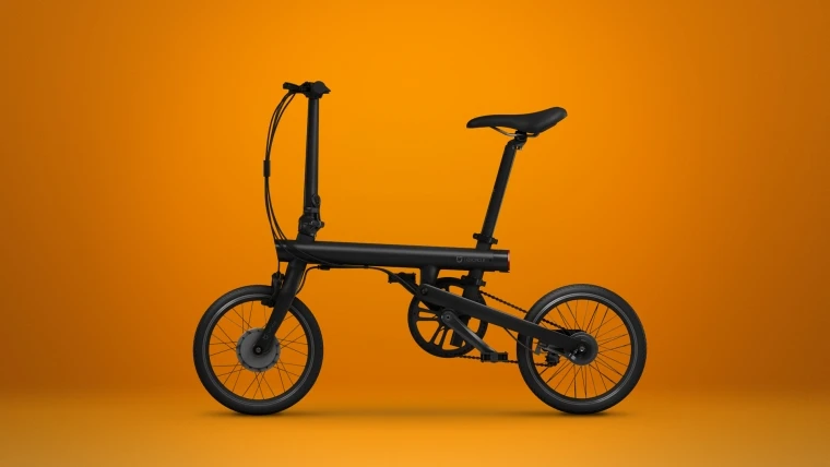 Qicycle weighs 14.5 kg, so it's not too difficult to lift into a car or train