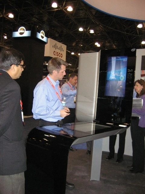 The kiosk gets a demo from Intel's Ed Hill and Joe Jensen