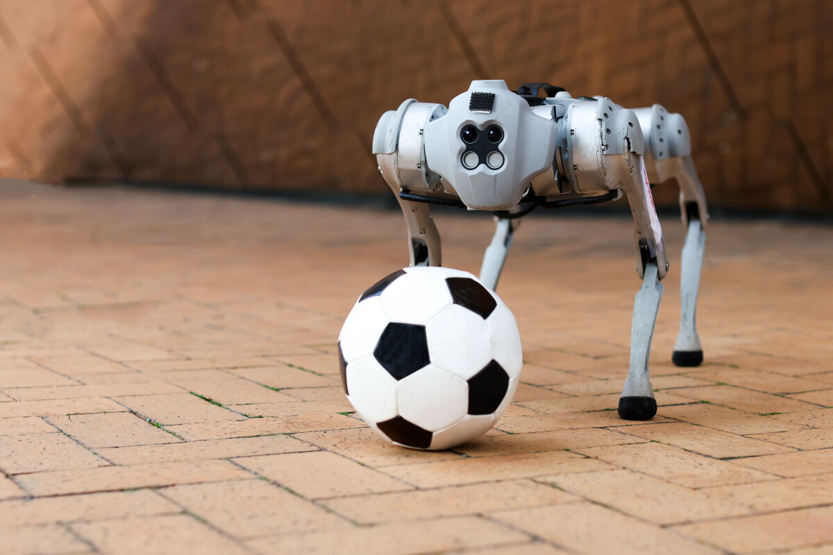 DribbleBot learns to dribble a soccer ball under realistic conditions