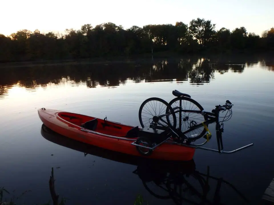 The Solo Shuttle Trailer lets you tow your kayak behind your bike, then mount your bike on your kayak