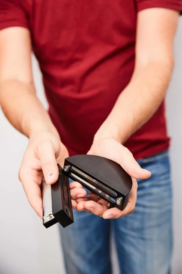 A harmonica is placed in the gasket and attached to the main Dyna-Mic body, which distributes the sound evenly before it's picked up by the internal microphone