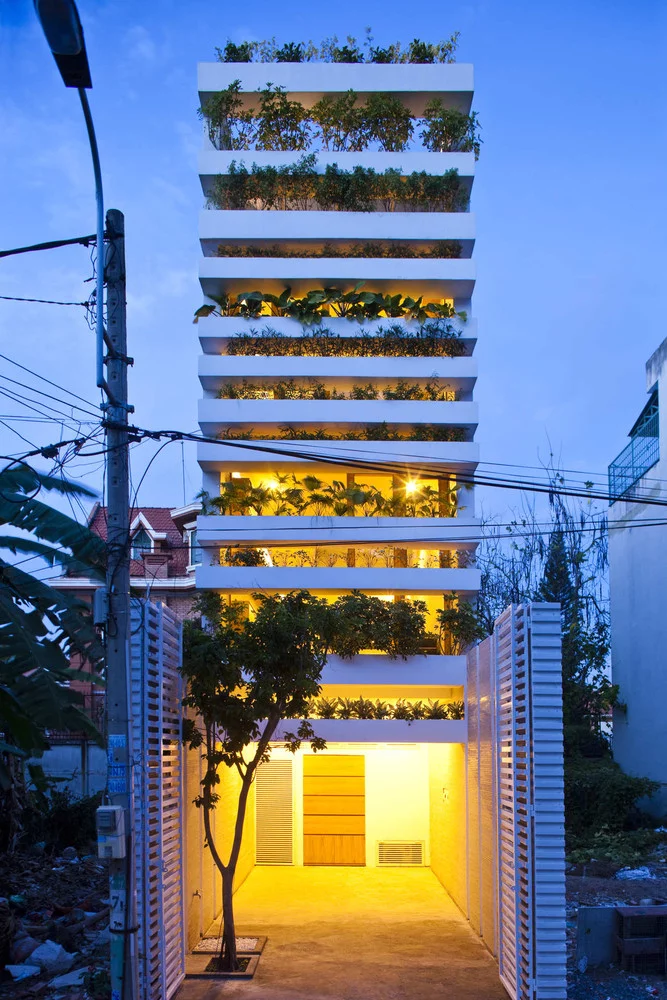 In Ho Chi Minh City, designed by VTN Architects is Stacking Green, on a plot only 157 in (4 mt) wide. The front and back walls of the building are entirely covered by stacked planter boxes making the entire facade green, contrasting the granite wall interiors