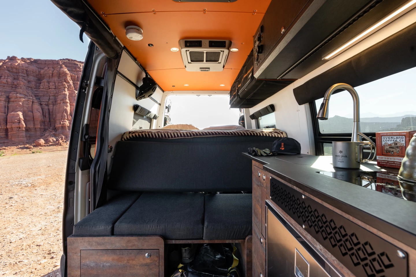 The back of the couch is also the front panel of the bed, folding upward at night to comple