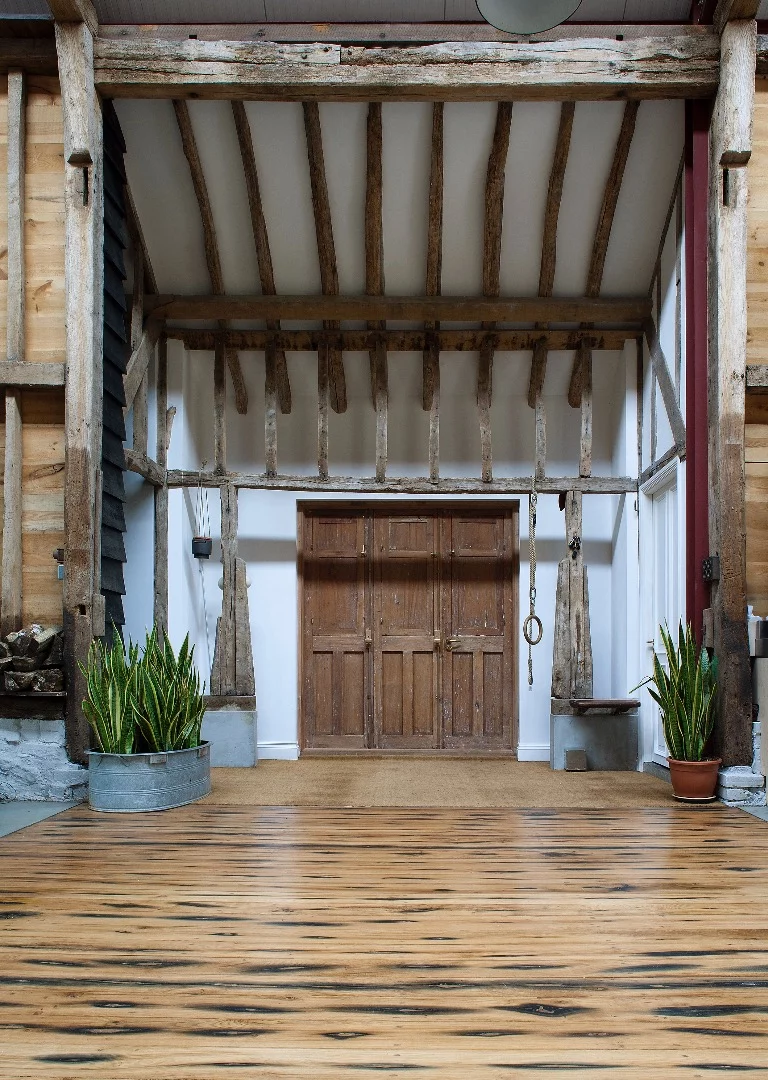 The barn's interior is dominated by restored original wood
