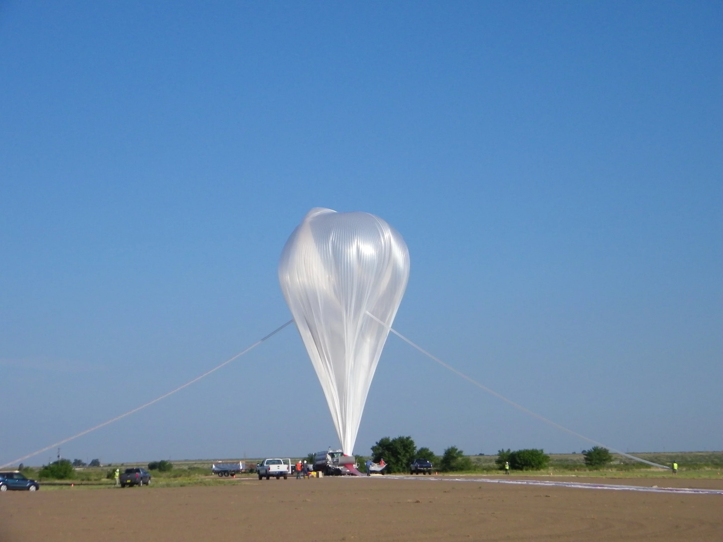 NASA's "Big 60" scientific balloon is a 60 million cubic foot monster, using 20 acres of super-strong polyethylene material thinner than kitchen wrap. It can lift a payload "the weight of a small four-wheeler," in excess of a metric ton, or reach sustainable altitudes up to 159,000 feet