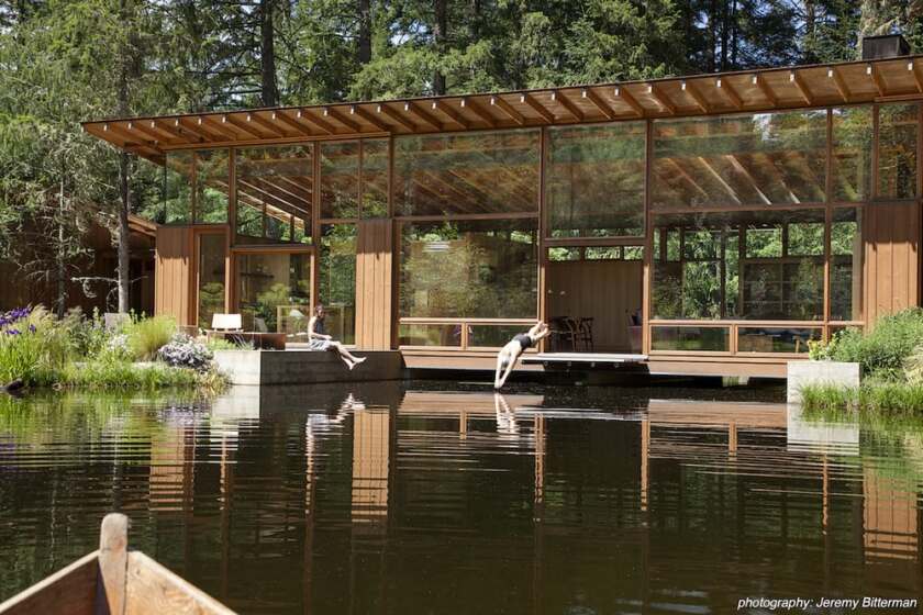 Cutler Anderson Architects' Newberg Residence is a luxury home that takes the form of a bridge over a large pond