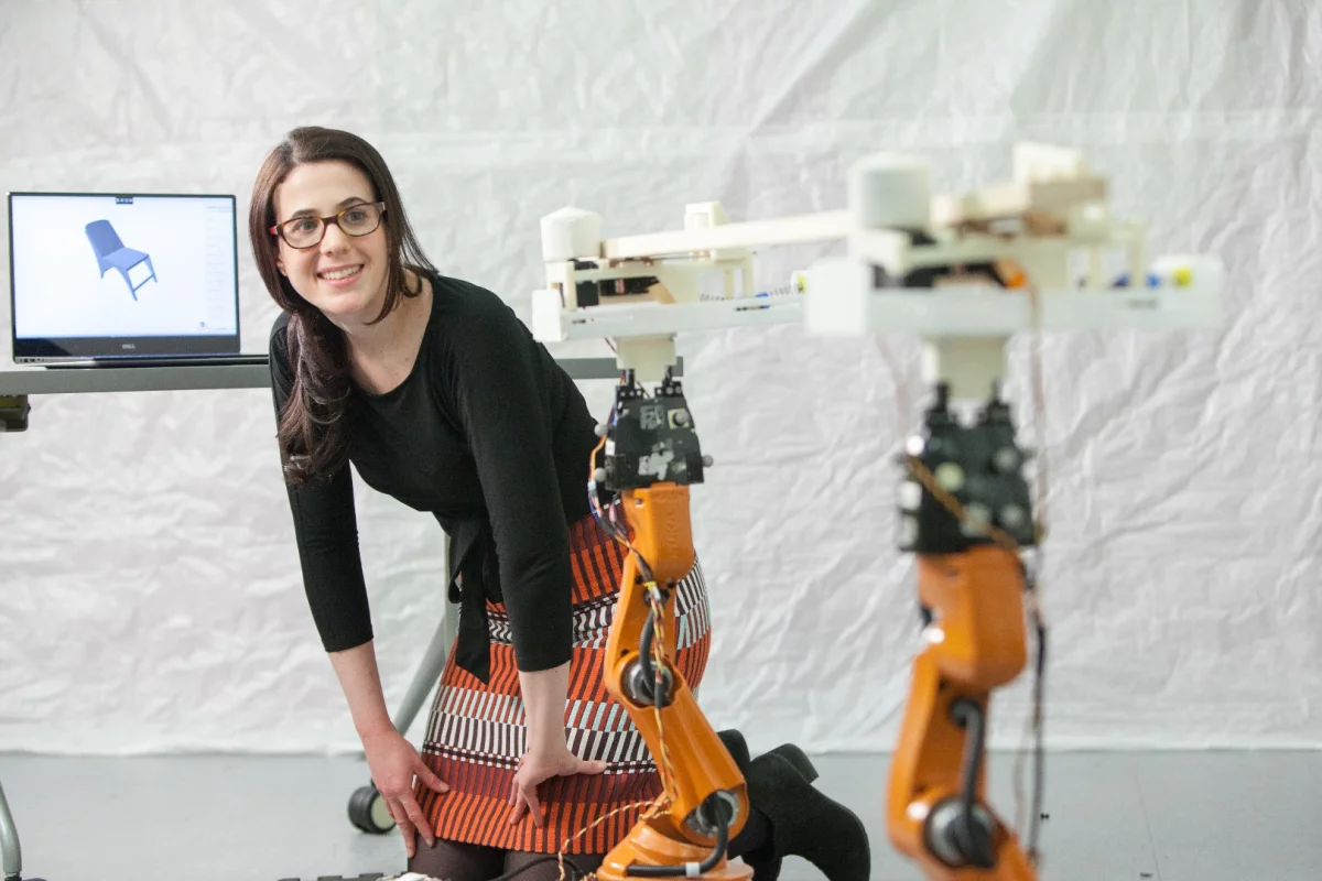 Adriana Schulz watches as the Kuka Youbots bring a piece of lumber to the chop saw