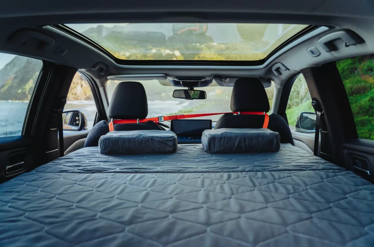 With a few straps, the MiniB kit secures in the vehicle and turns it into a tiny mobile bedroom