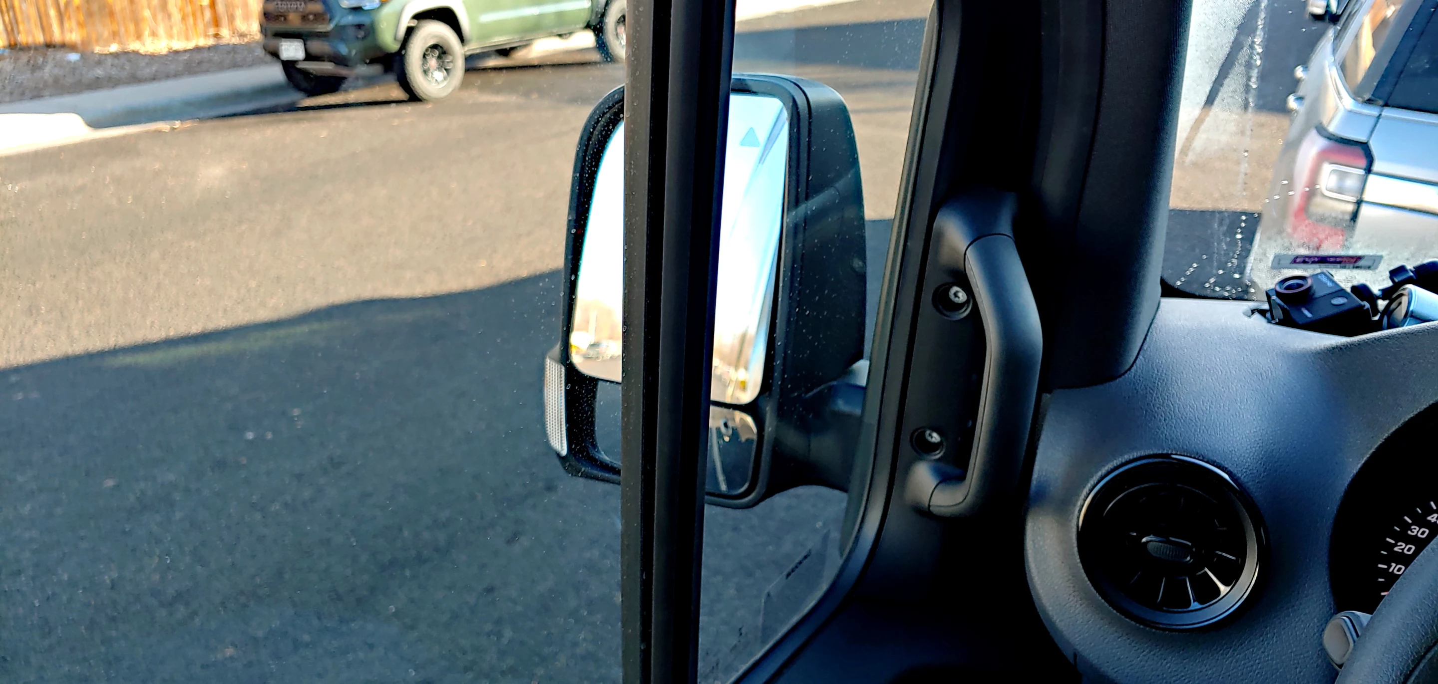 The window track bisecting the sideview mirror on the driver's side of the Sprinter is a huge oversight in design