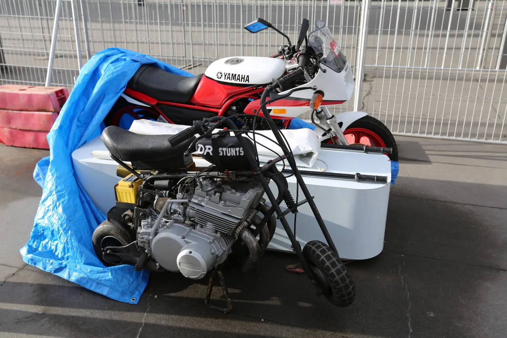We don't know anything about this bike except the person that built it may be in need of some counseling. It's a monkey bike with what appears to be either a Suzuki 380cc or 550cc three-cylinder two-stroke motor. It was seen in the paddock and with a minimal wheelbase and a brutal motor, it would need expert riding to avoid it beating the rider to death.