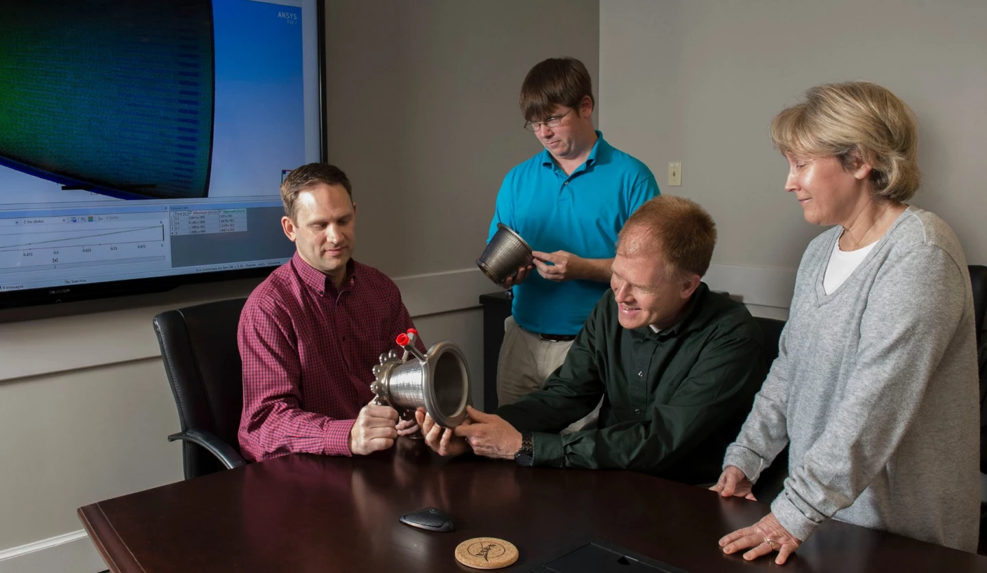 Engineers from NASA Marshall Space Flight Center's Propulsion Department examine nozzles fabricated using a freeform-directed energy wire deposition process