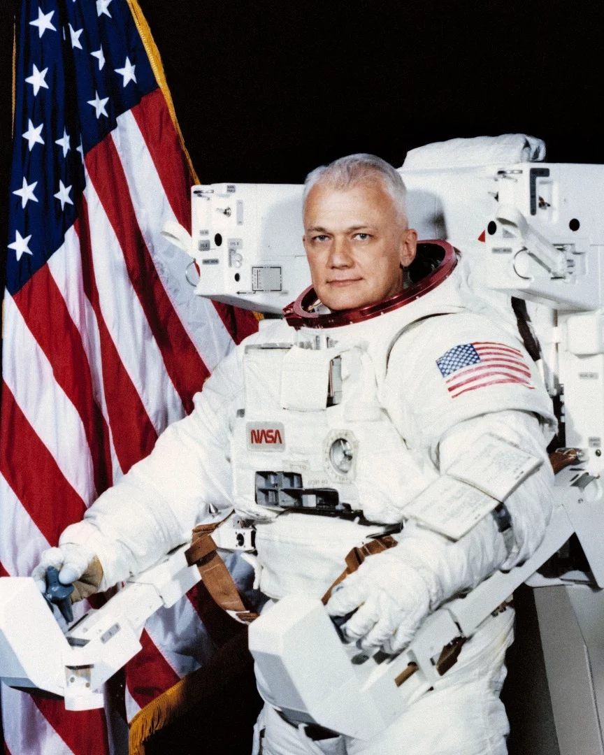 Official Space Shuttle portrait showing Astronaut Bruce McCandless II, attired in the Shuttle Extravehicular Activity (EVA) Suit with Manned Maneuvering Unit (MMU) attached